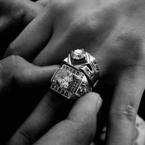 Ring Designs For Men; Man Wearing Two Rings Checking for Options