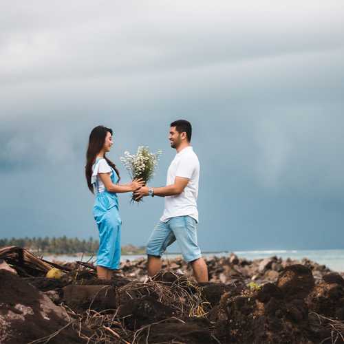 Guy Proposing To A Girl On A Rocky Hill Near The Sea